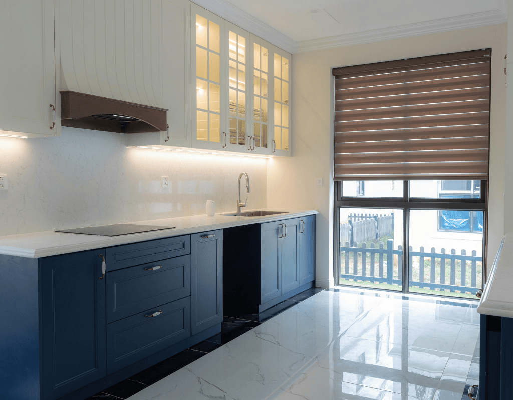 Custom kitchen remodel in Rexburg, Idaho featuring modern blue cabinetry, quartz countertops, and upgraded lighting