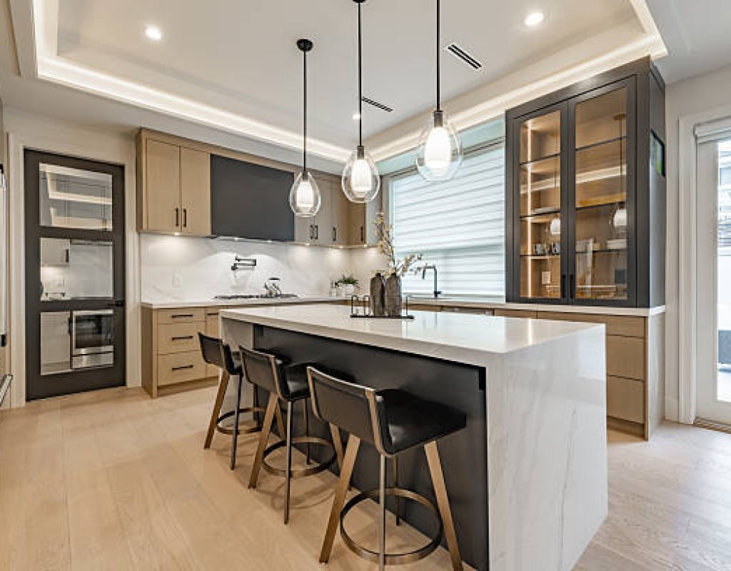 Experienced remodelers installing custom cabinetry in a modern Idaho Falls, ID kitchen renovation
